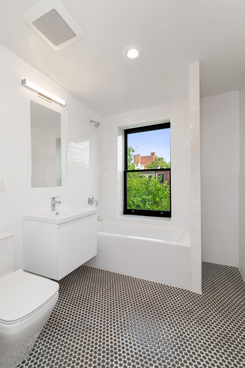 354 Macon Street, Unit 2 Brooklyn, NY 11233 - Photo 9 of 13 a bathroom with a sink a toilet and bathtub