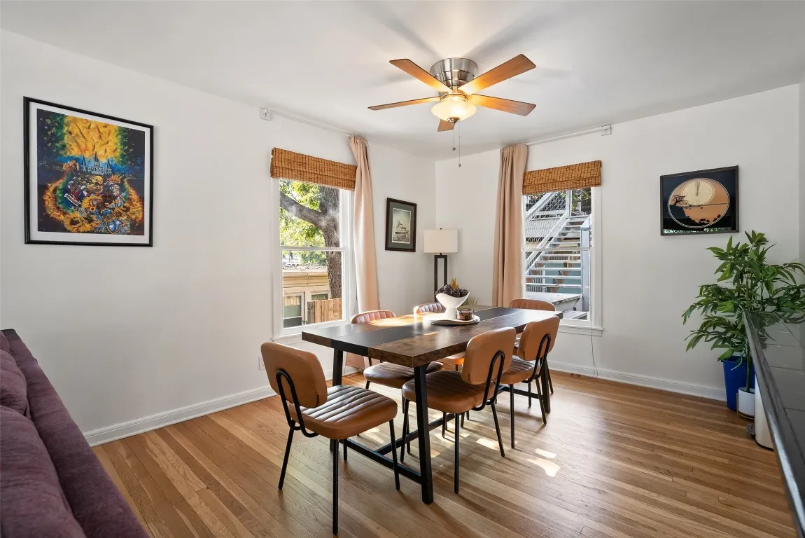 a view of a dining room with furniture and wooden floor