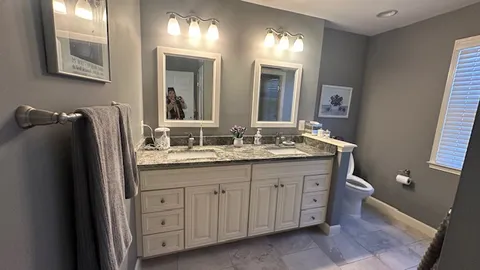 a spacious bedroom with a bed a desk and chair