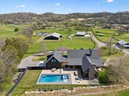 an aerial view of a house with outdoor space swimming pool and mountains