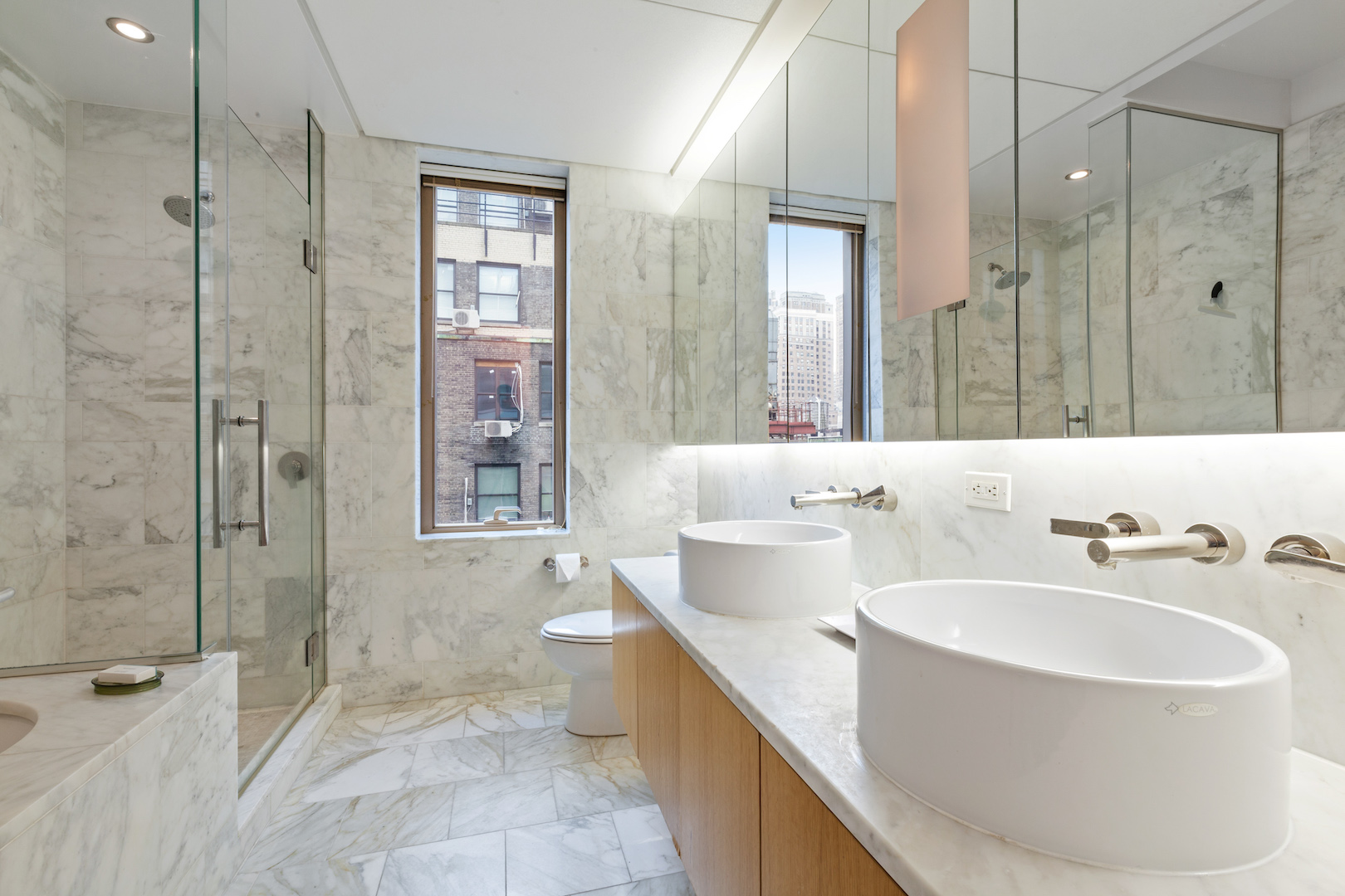 18 West 48th Street, Unit 17C Manhattan, NY 10036 - Photo 4 of 5 a bathroom with a bathtub and a sink