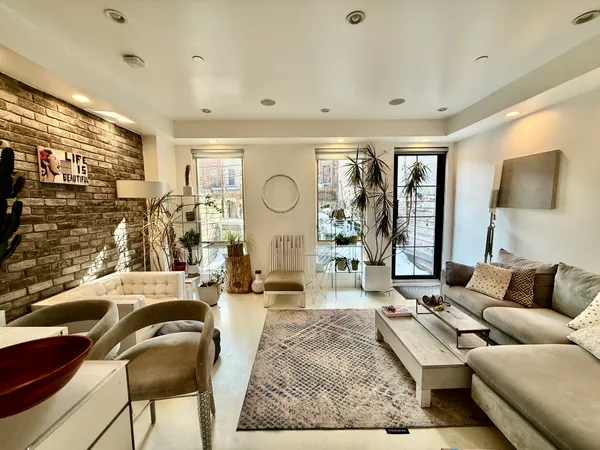 a living room with furniture and a large window