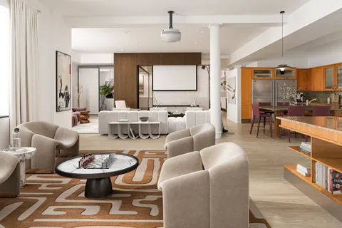 a living room with furniture a rug and a large window