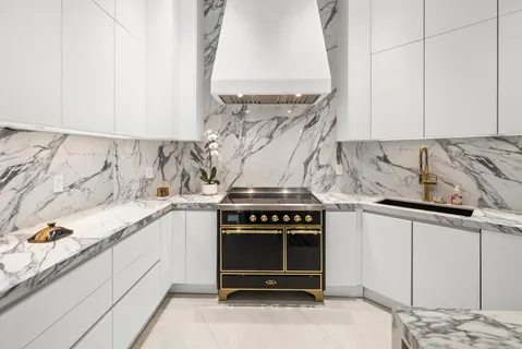 a kitchen with granite countertop a stove and a sink