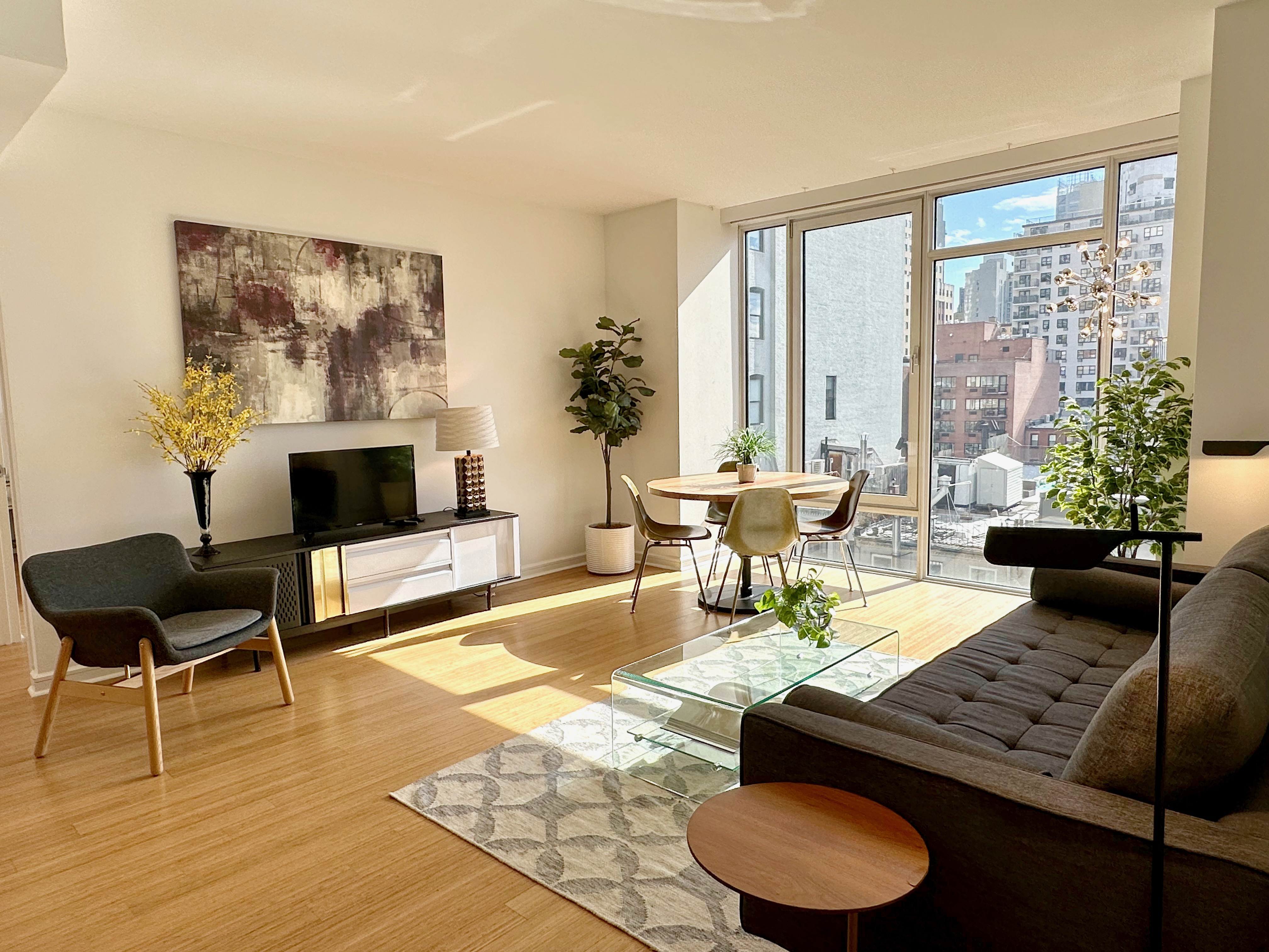 350 West 53rd Street, Unit PHA Manhattan, NY 10019 - Photo 3 of 35 a living room with furniture and a large window