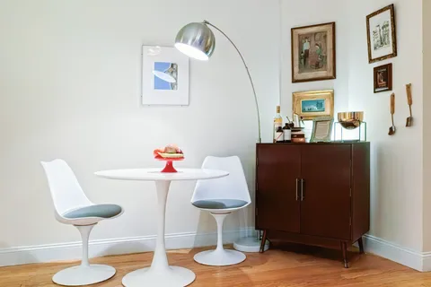 a dining room with furniture and wooden floor