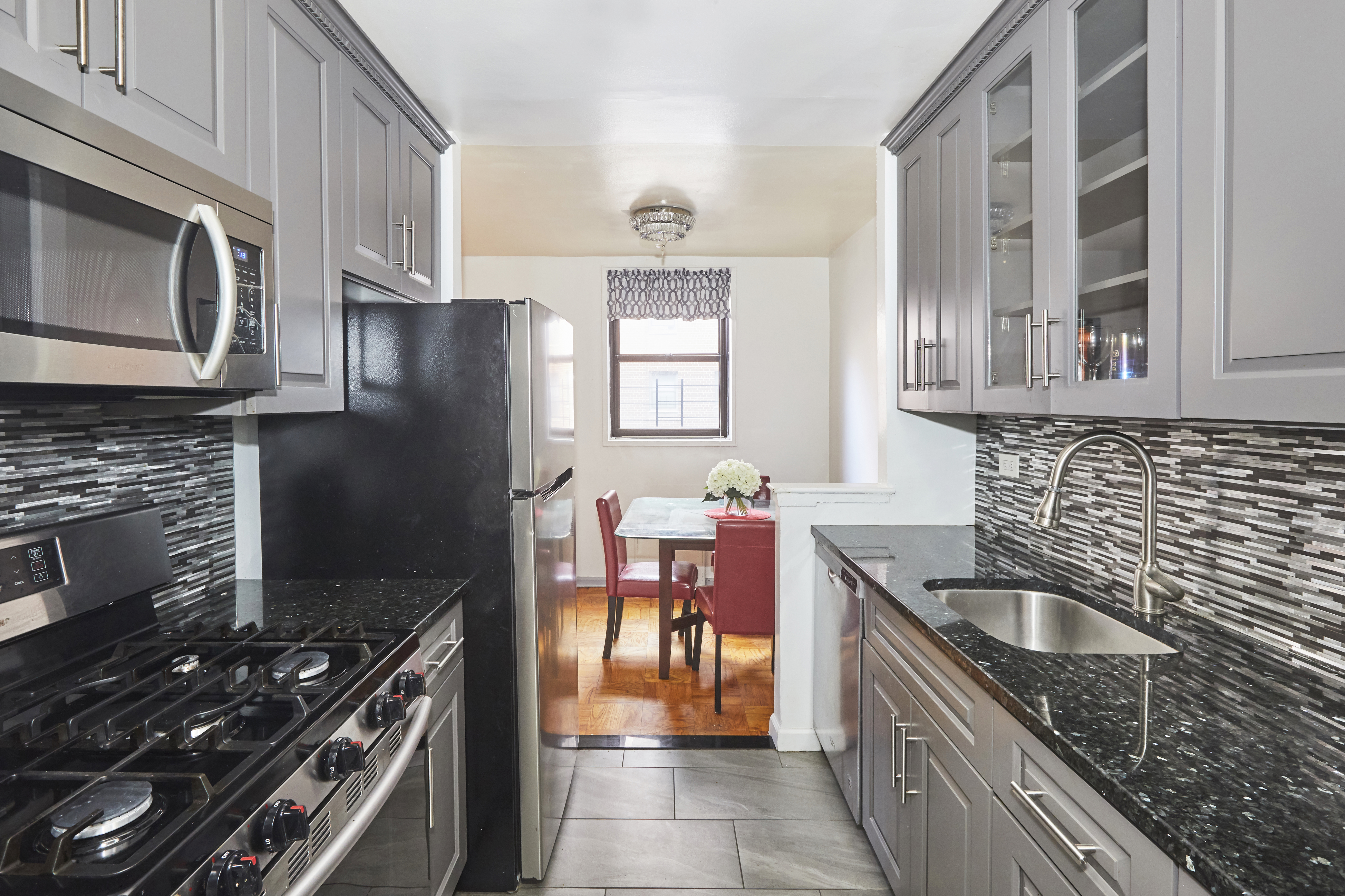 1165 East 54th Street, Unit 2P Brooklyn, NY 11234 - Photo 1 of 6 a kitchen with stainless steel appliances granite countertop a sink stove and refrigerator