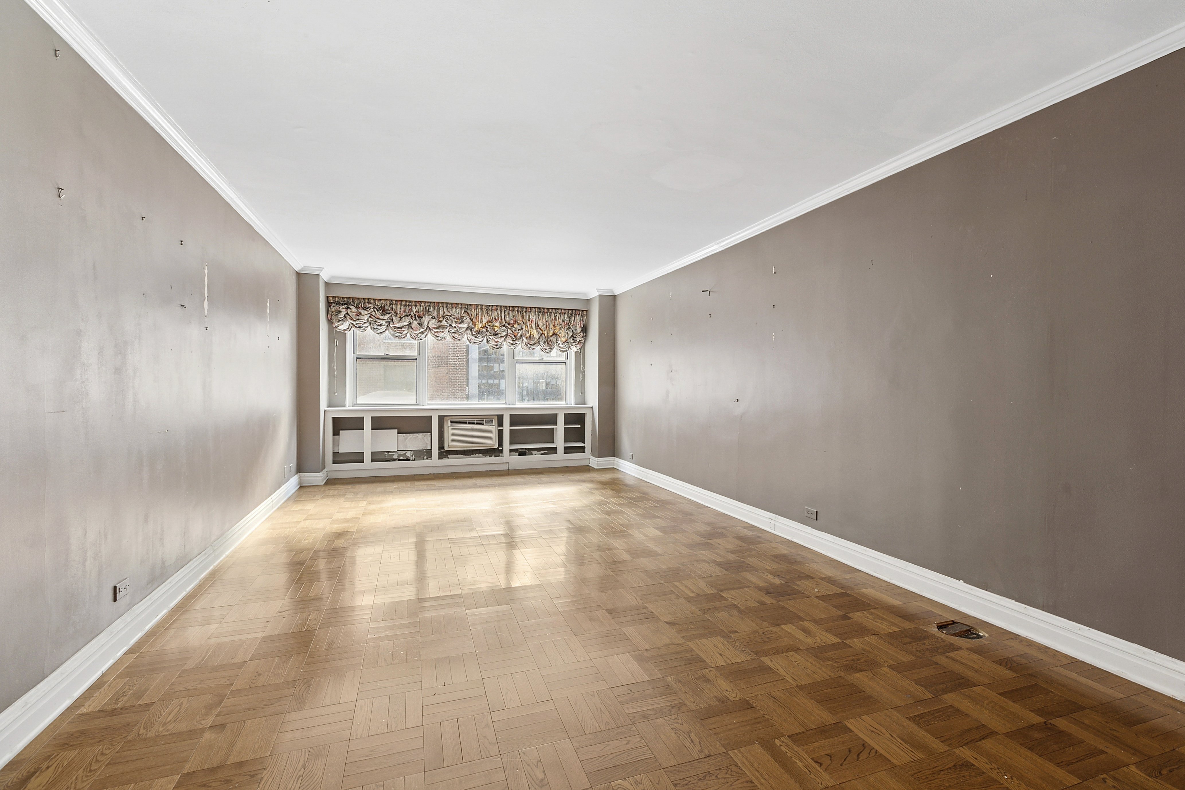 1175 York Avenue, Unit 6C Manhattan, NY 10065 - Photo 2 of 12 wooden floor in an empty room with a window