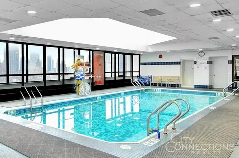 a view of a swimming pool with outdoor seating