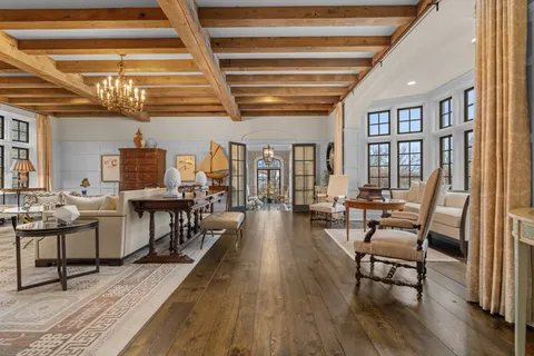 a living room with lots of furniture and wooden floor
