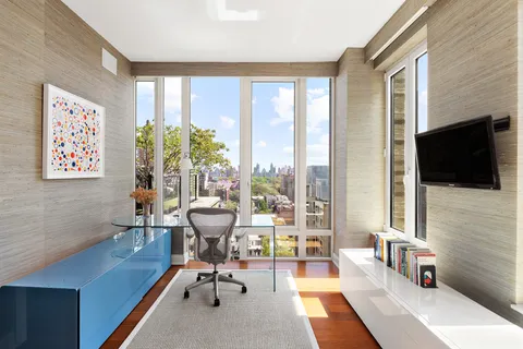 a living room with furniture tv and a flat screen tv