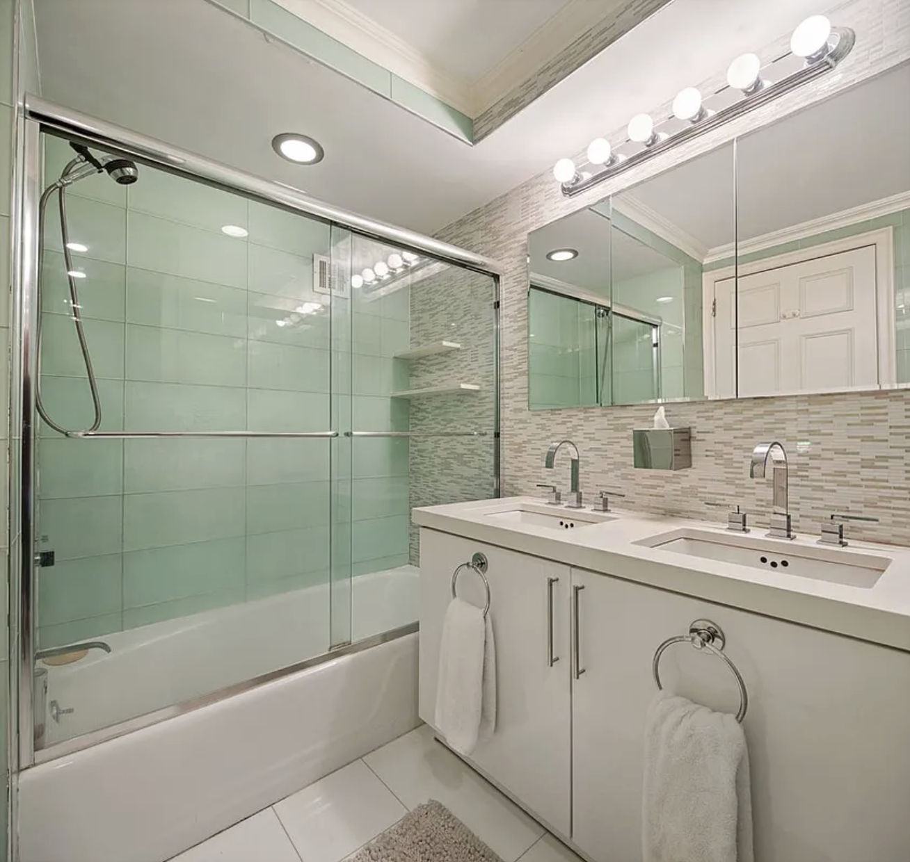 1441 3rd Avenue, Unit 14A Manhattan, NY 10028 - Photo 6 of 10 a bathroom with a granite countertop sink mirror and a bathtub