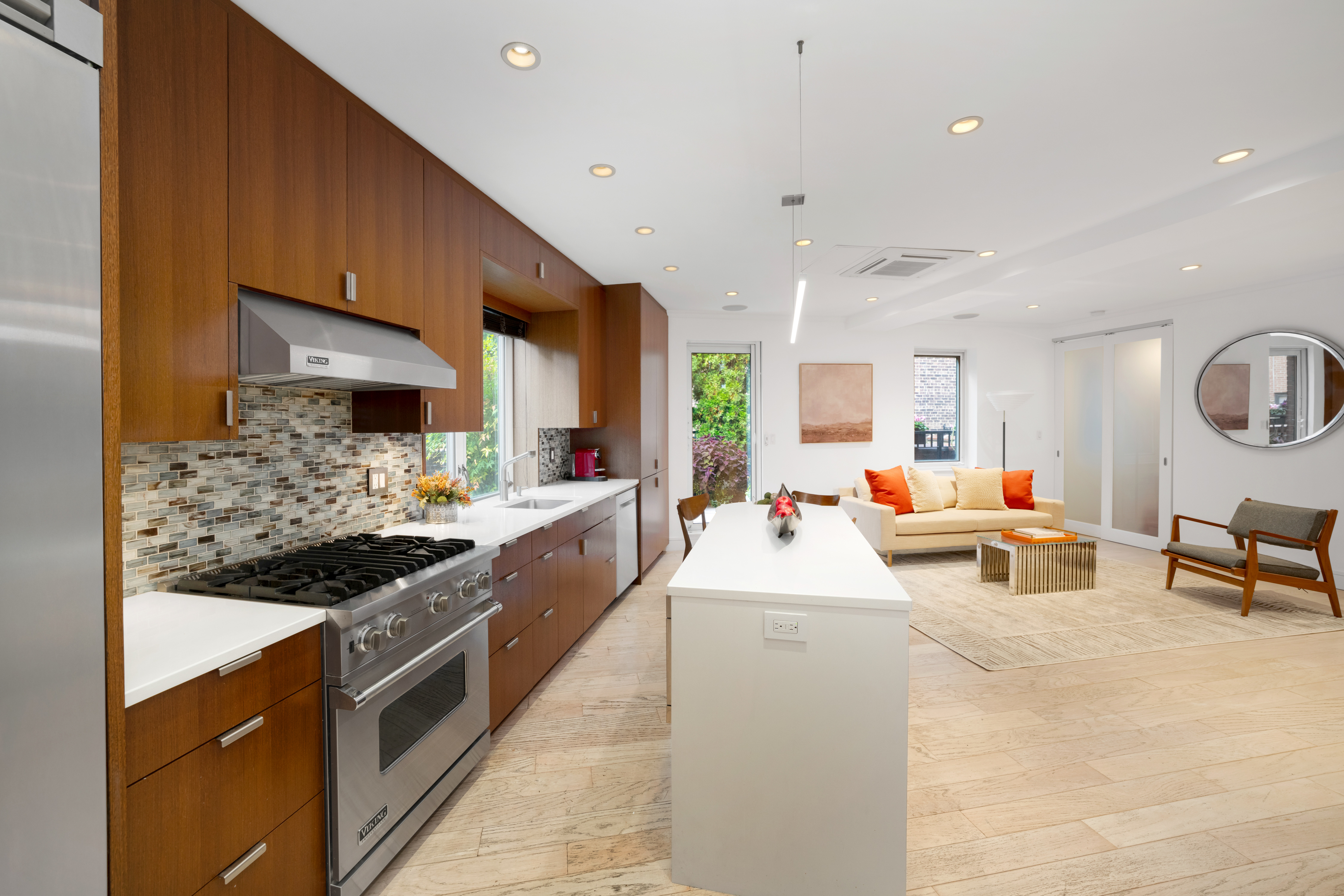 314 East 41st Street, Unit PH2B Manhattan, NY 10017 - Photo 3 of 13 a large white kitchen with stainless steel appliances kitchen island granite countertop a large counter top and stove
