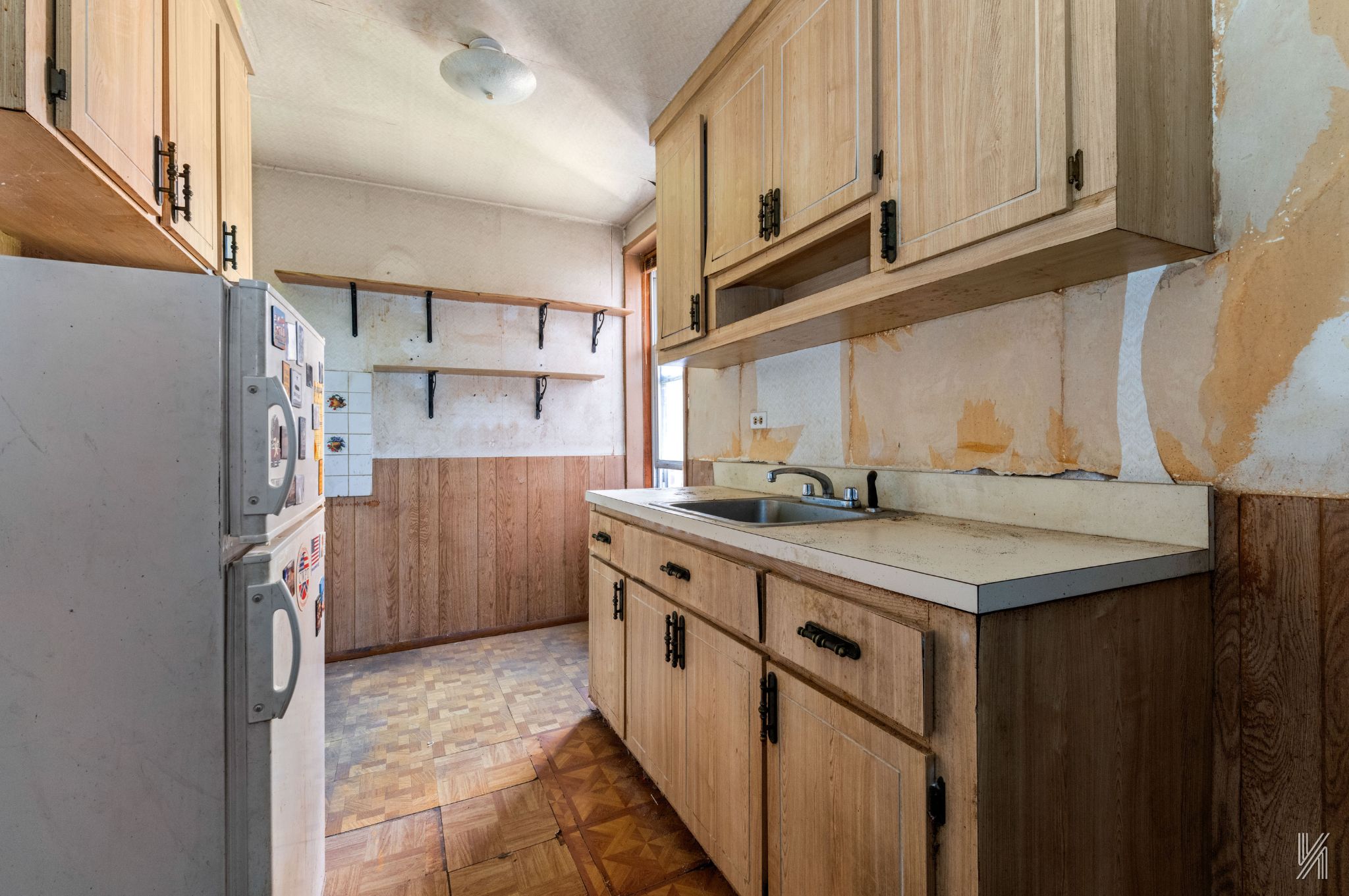 33-04 91st Street, Unit 5L Queens, NY 11372 - Photo 9 of 17 a kitchen with a sink stove and cabinets