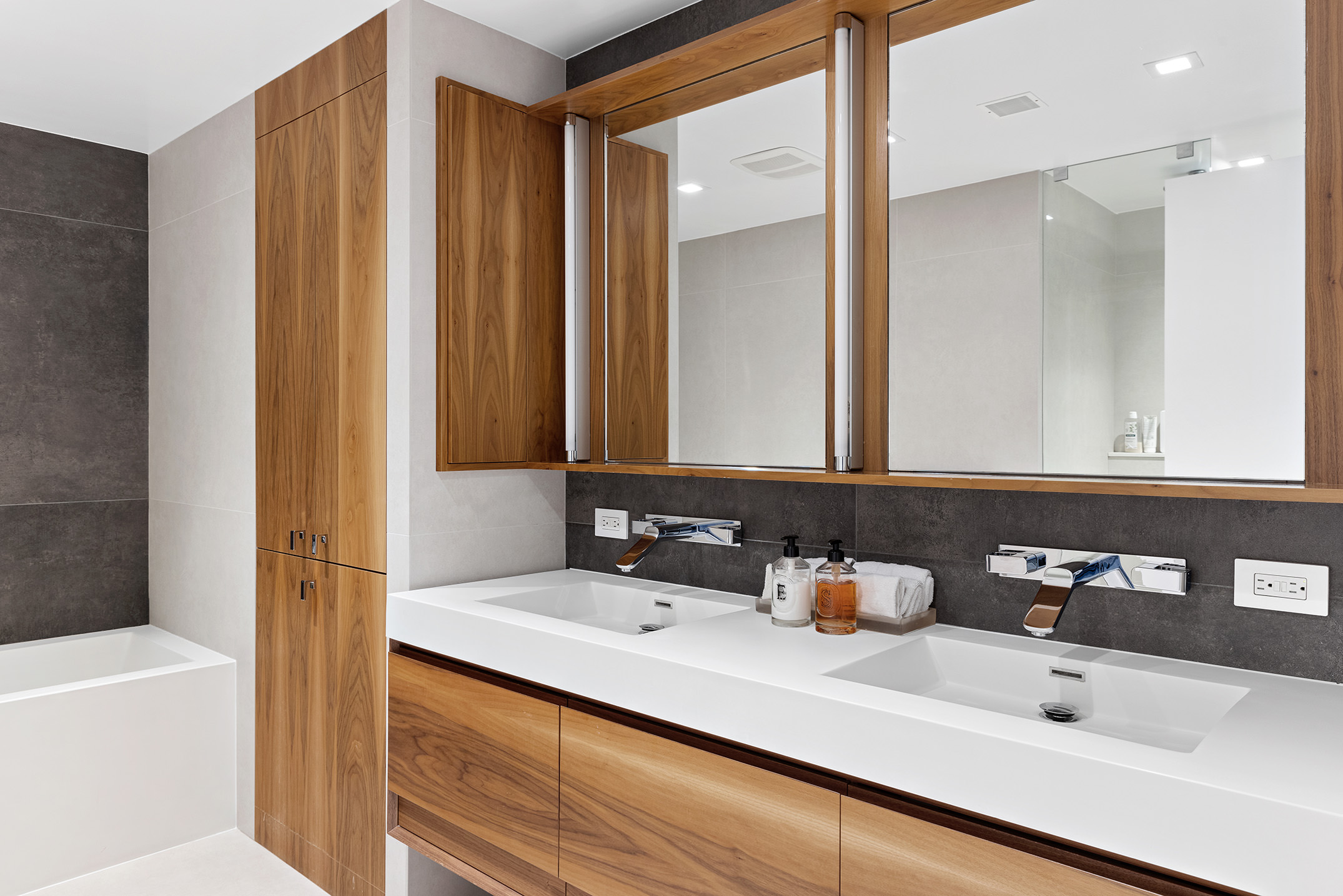 525 East 80th Street, Unit 11BC Manhattan, NY 10075 - Photo 9 of 16 a bathroom with a sink and a mirror