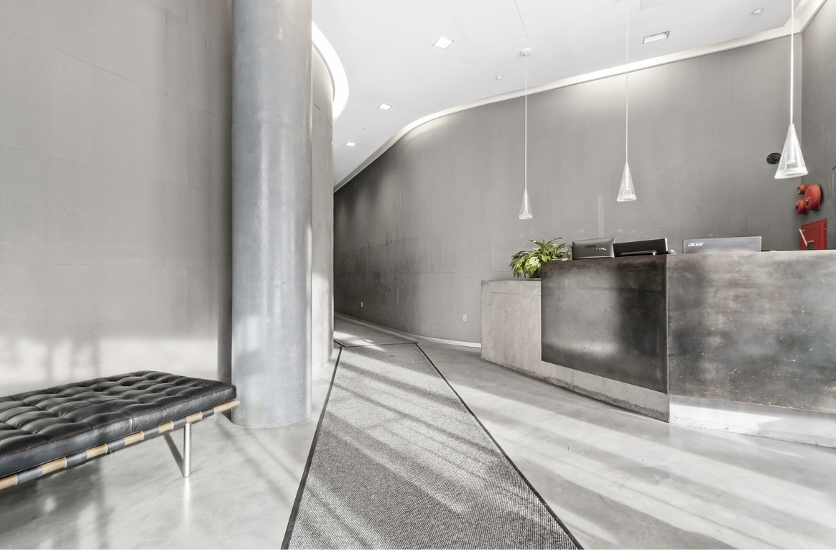 475 Greenwich Street, Unit 5B Manhattan, NY 10013 - Photo 14 of 16 a kitchen with stainless steel appliances kitchen island granite countertop a refrigerator and a stove