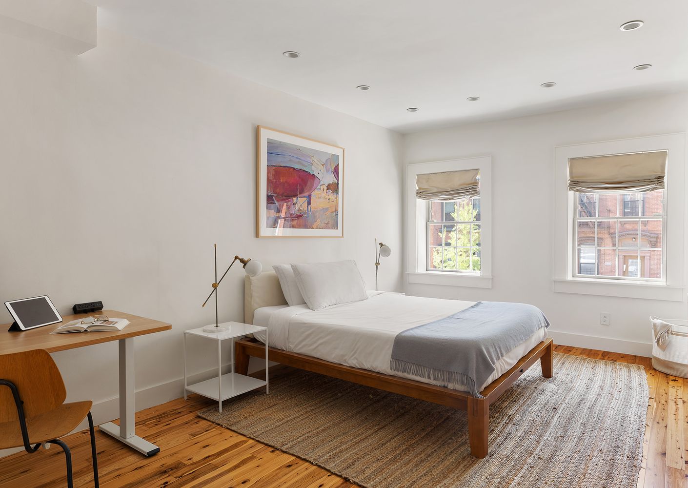 a bedroom with a bed and wooden floor