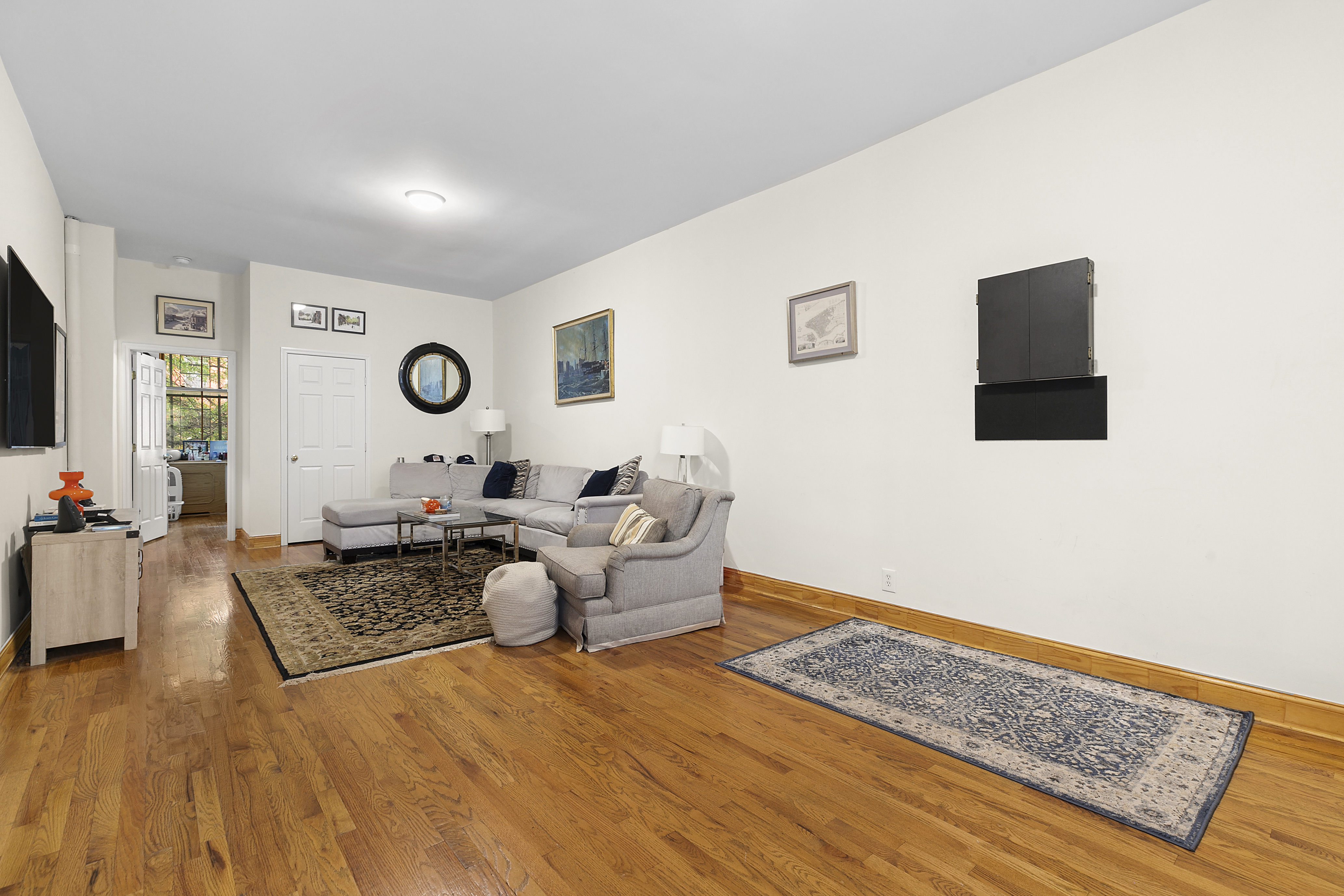 548 1/2 Hudson Street, Unit 2 Manhattan, NY 10014 - Photo 2 of 6 a living room with furniture and a flat screen tv