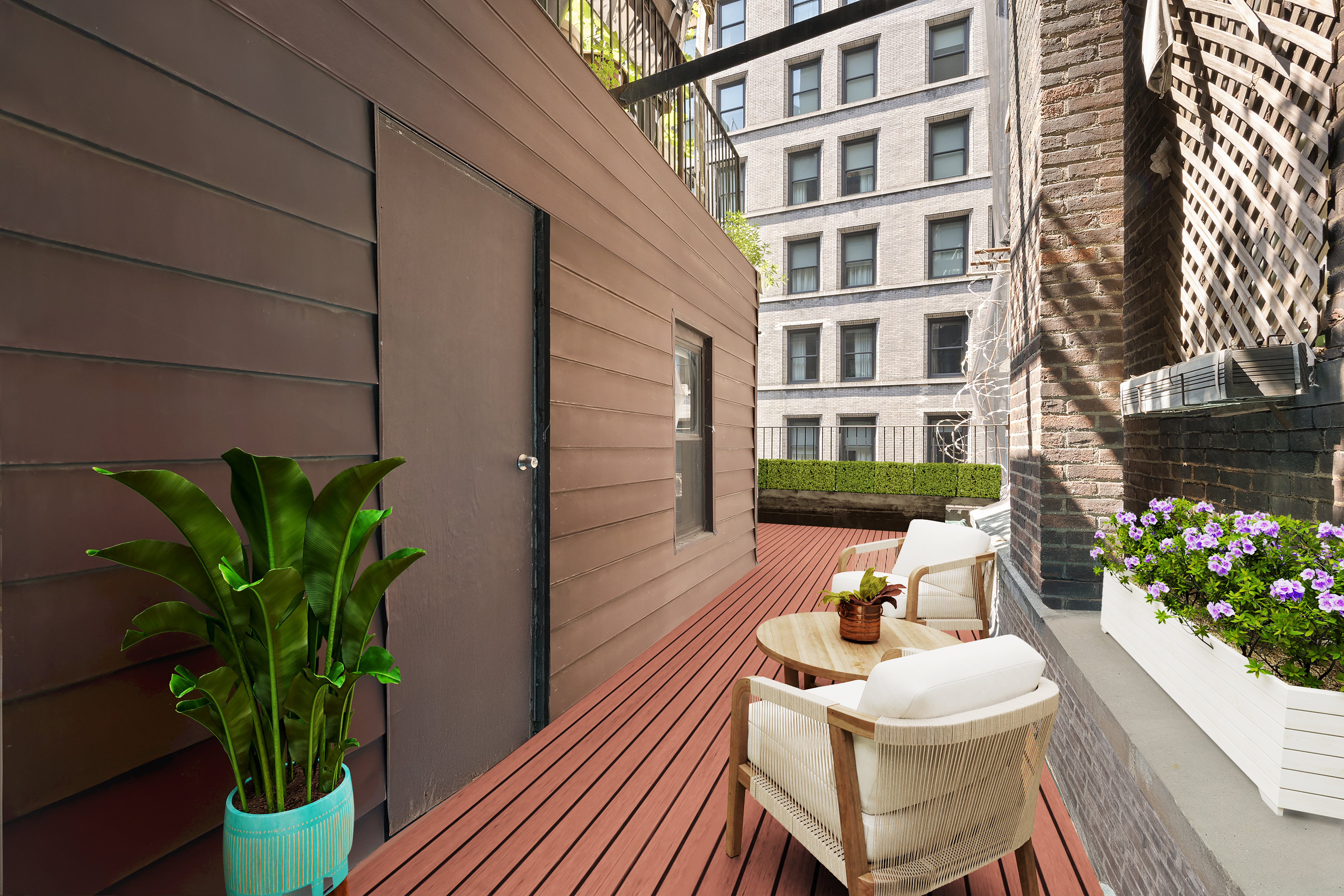 176 Broadway, Unit 9F Manhattan, NY 10038 - Photo 7 of 9 a view of a balcony with chairs and a potted plant