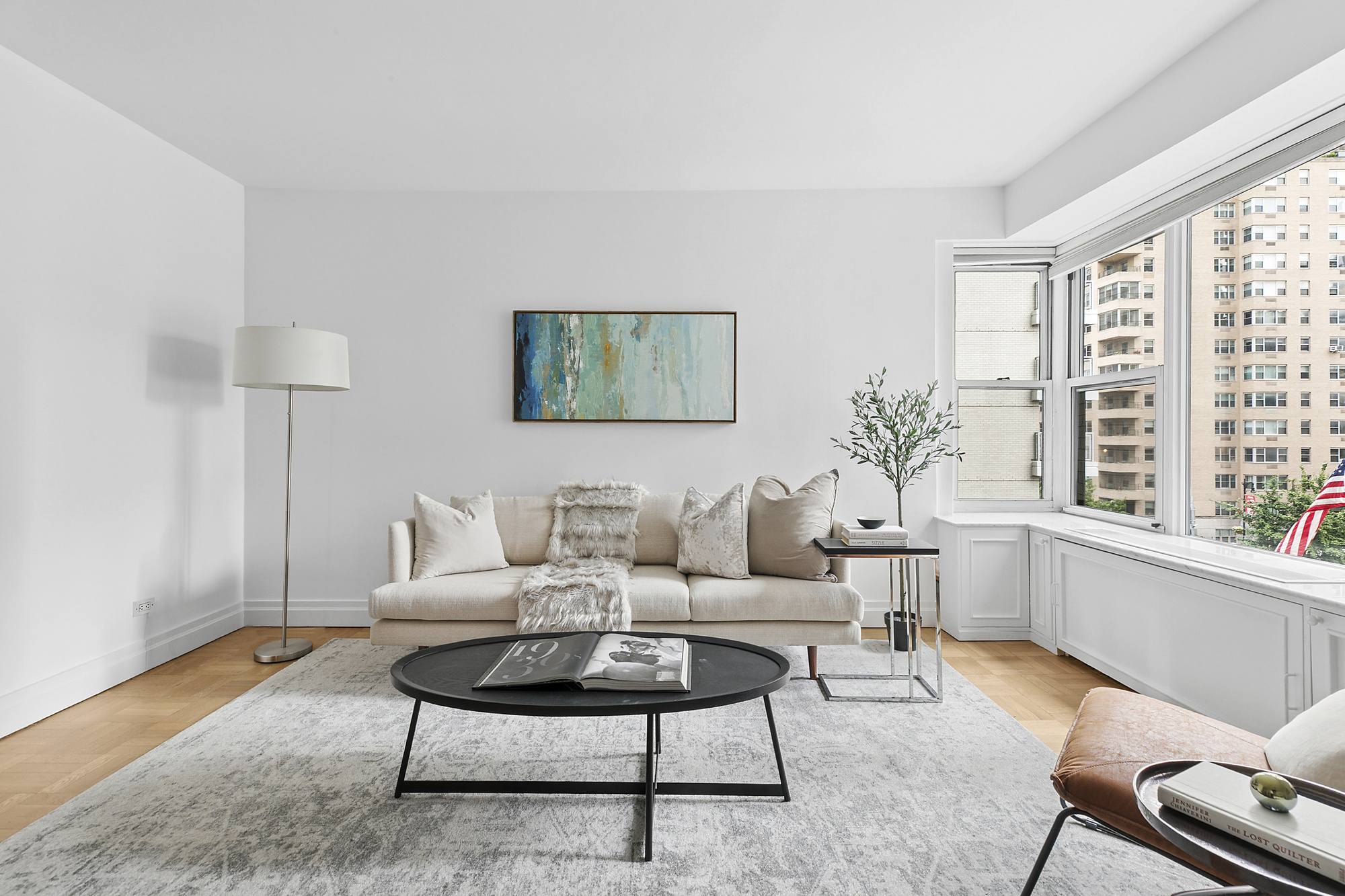 2 5th Avenue, Unit 5B Manhattan, NY 10011 - Photo 3 of 12 a living room with furniture and a large window