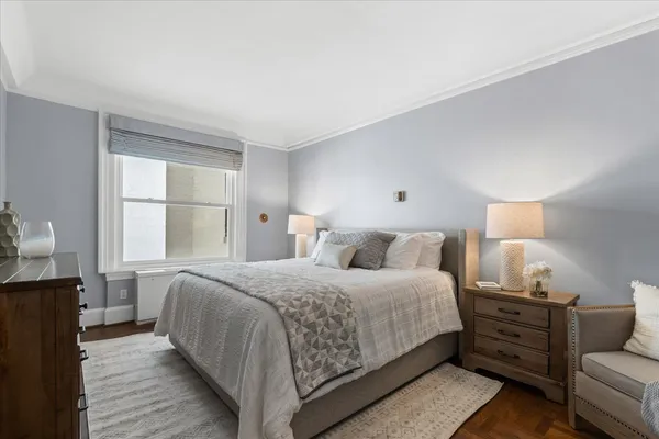 a living room with furniture chandelier and a flat screen tv