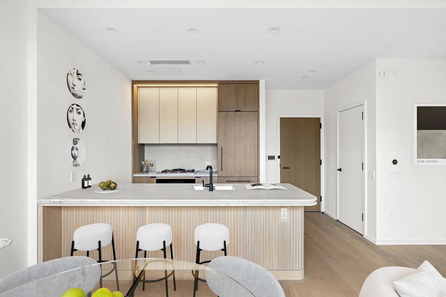 a living room with furniture a sink and a window