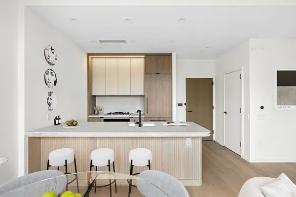 a living room with furniture a sink and a window