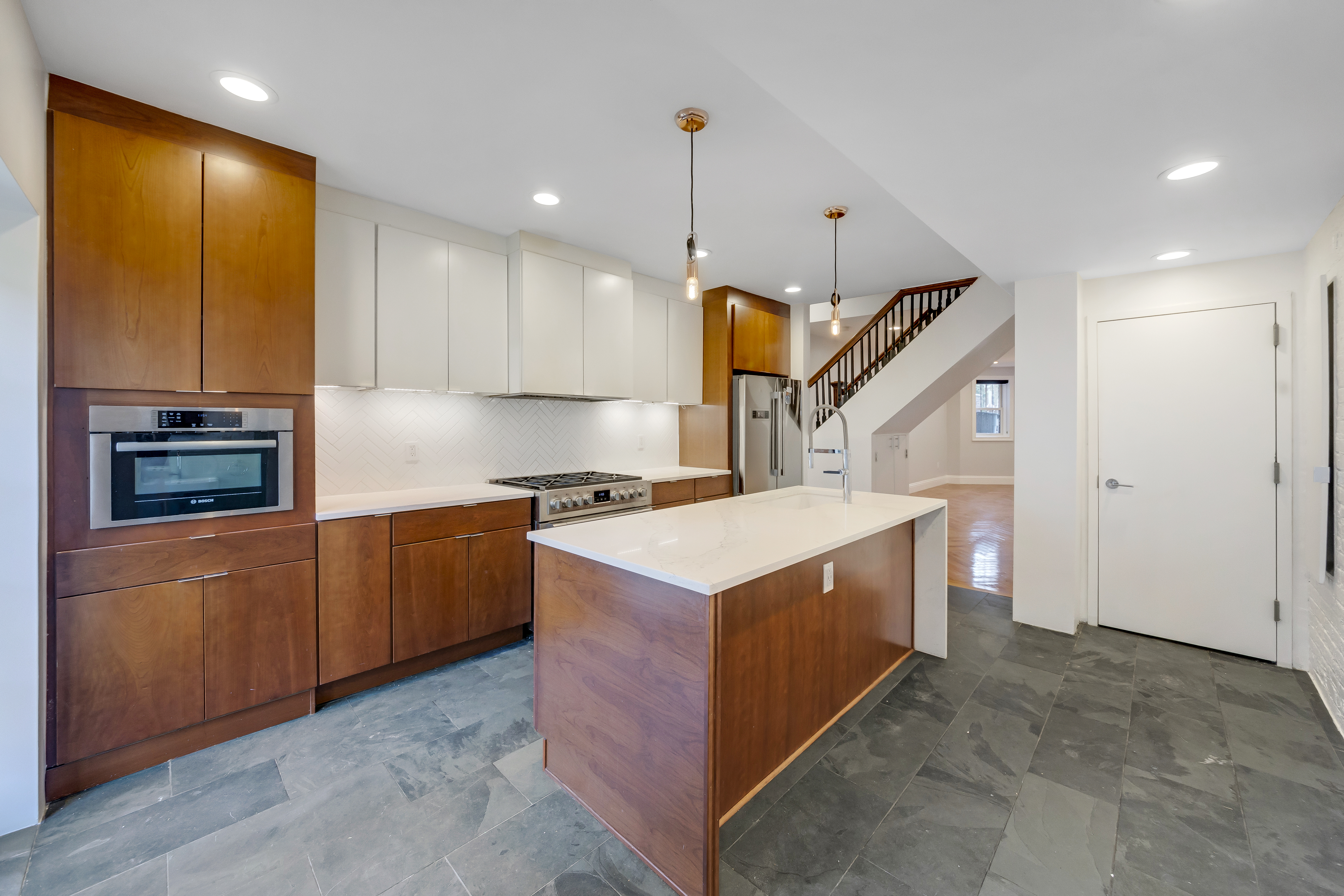 57 Hendrix Street, Unit 1 Brooklyn, NY 11207 - Photo 5 of 12 a kitchen with stainless steel appliances granite countertop a stove a sink and a refrigerator