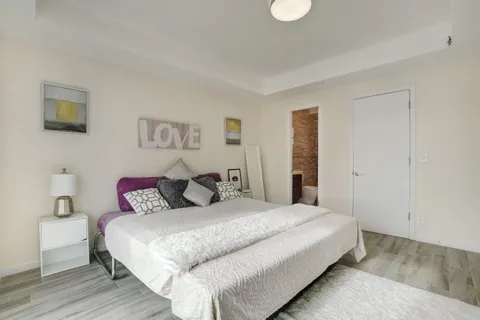 a bedroom with a bed and a lamp