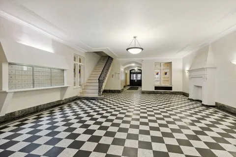 a bathroom with a black white checkered floor