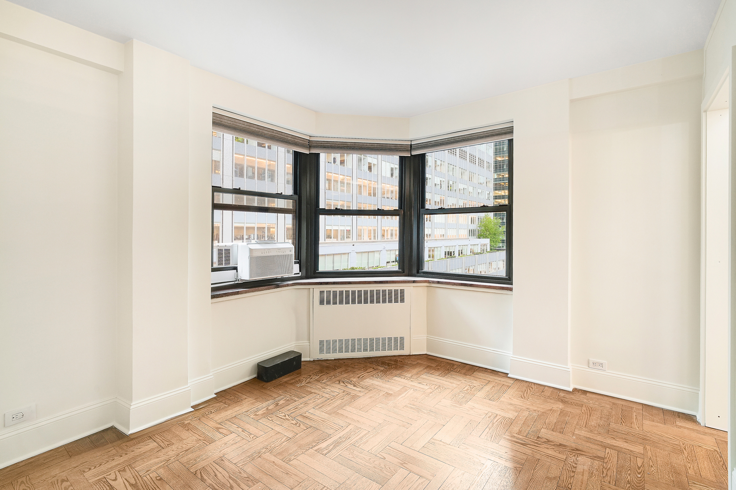 135 East 54th Street, Unit 12M Manhattan, NY 10022 - Photo 5 of 10 an empty room with windows