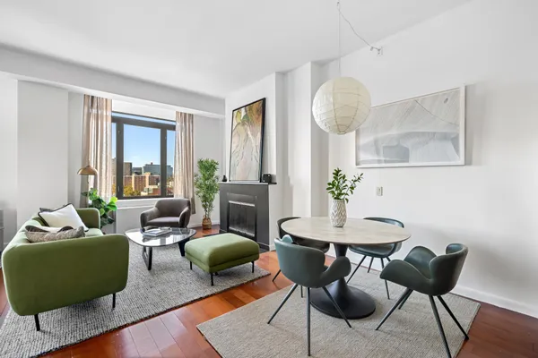 a living room with furniture a window and a chandelier