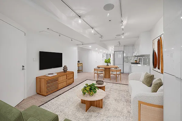 164 Sterling Street, Unit GARDEN Brooklyn, NY 11225 - Photo 2 of 5 a living room with furniture a flat screen tv and kitchen view