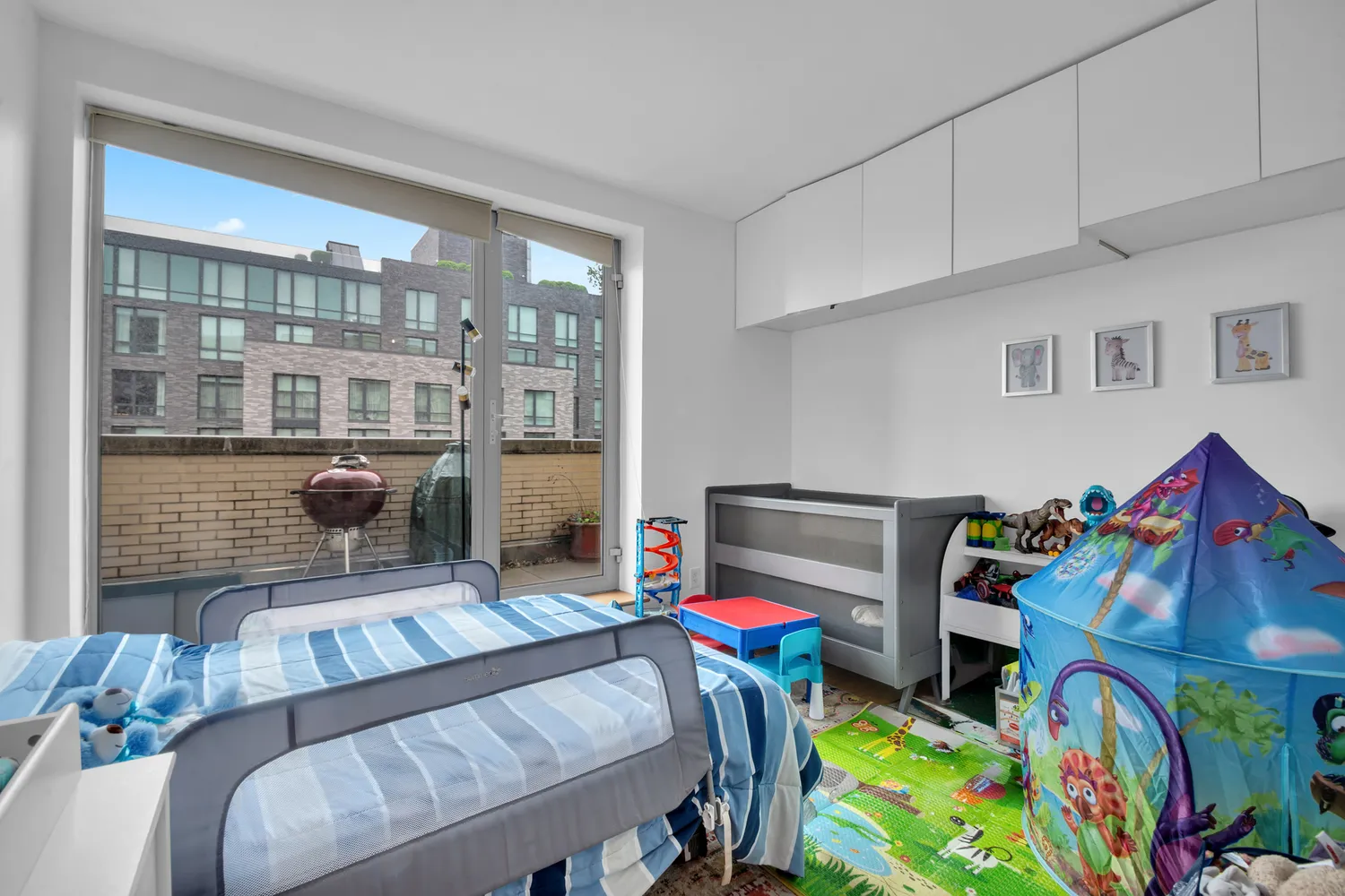 a bedroom with furniture and a baby crib
