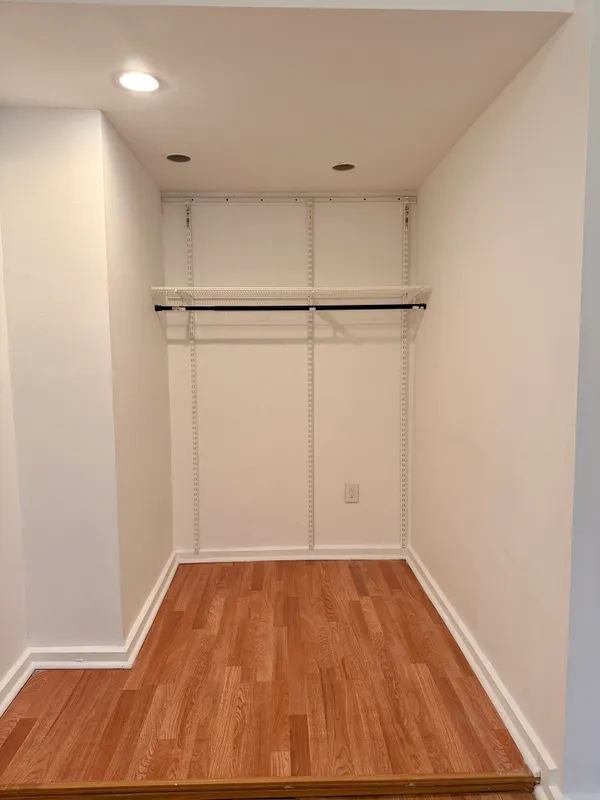 a view of a room with wooden floor