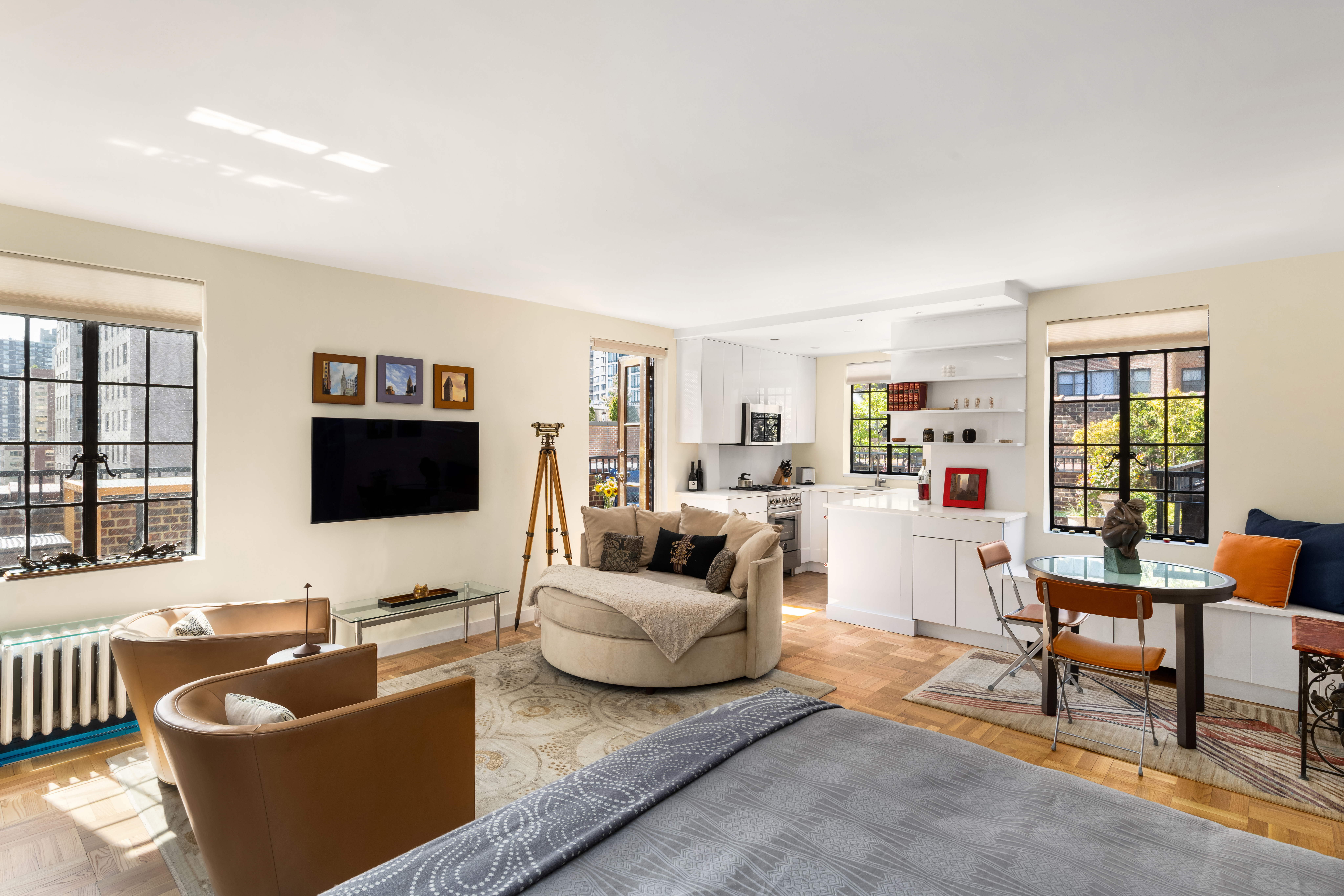 324 East 41st Street, Unit 1103C Manhattan, NY 10017 - Photo 4 of 13 a living room with furniture and a flat screen tv