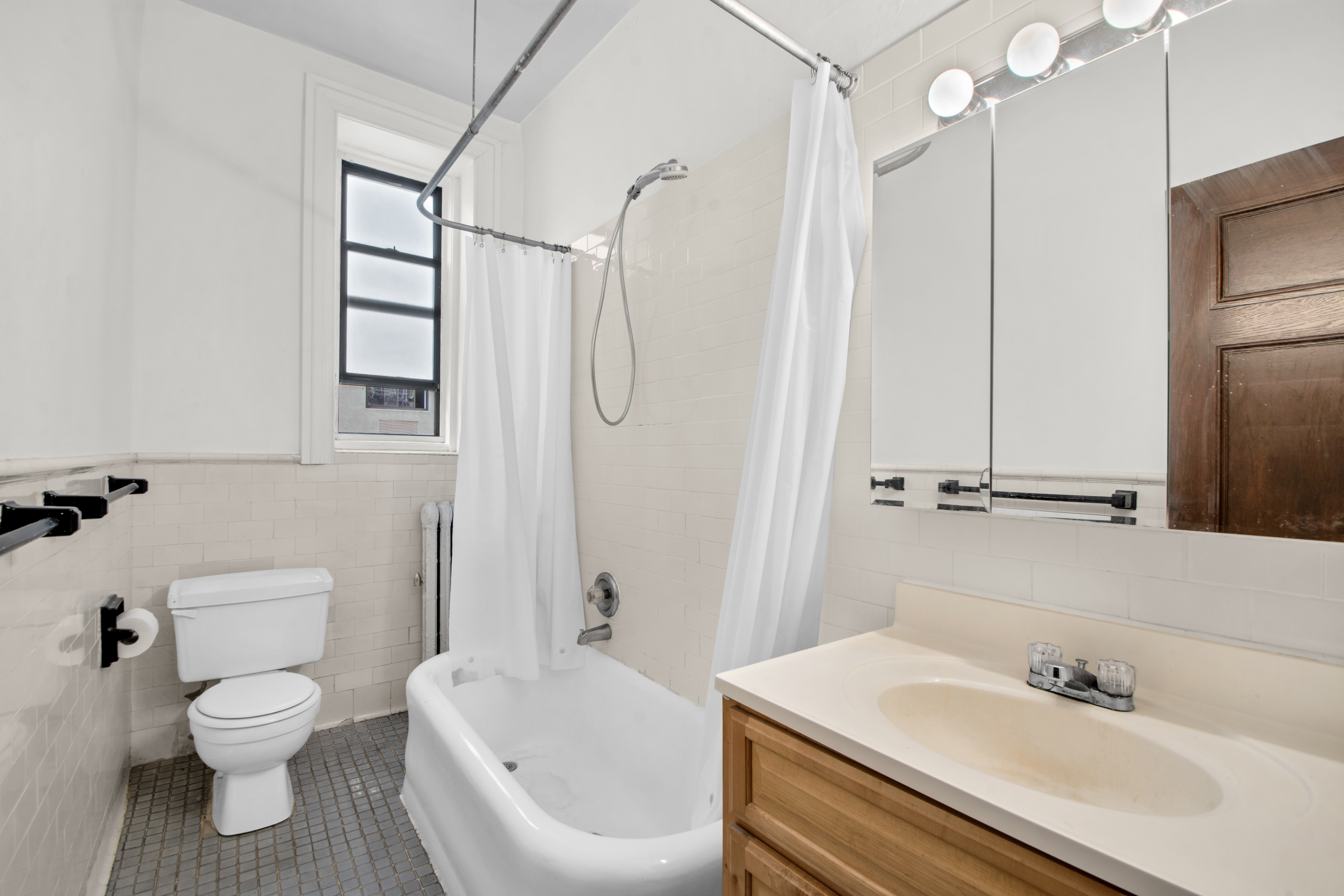 244 Riverside Drive, Unit 4D Manhattan, NY 10025 - Photo 6 of 9 a bathroom with a sink toilet and shower