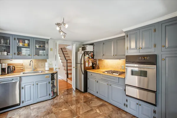 a kitchen with a sink stove and cabinets