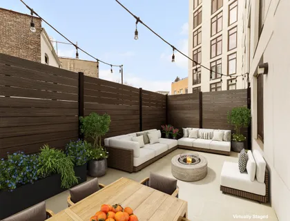 a view of a patio with couches table and chairs and potted plants