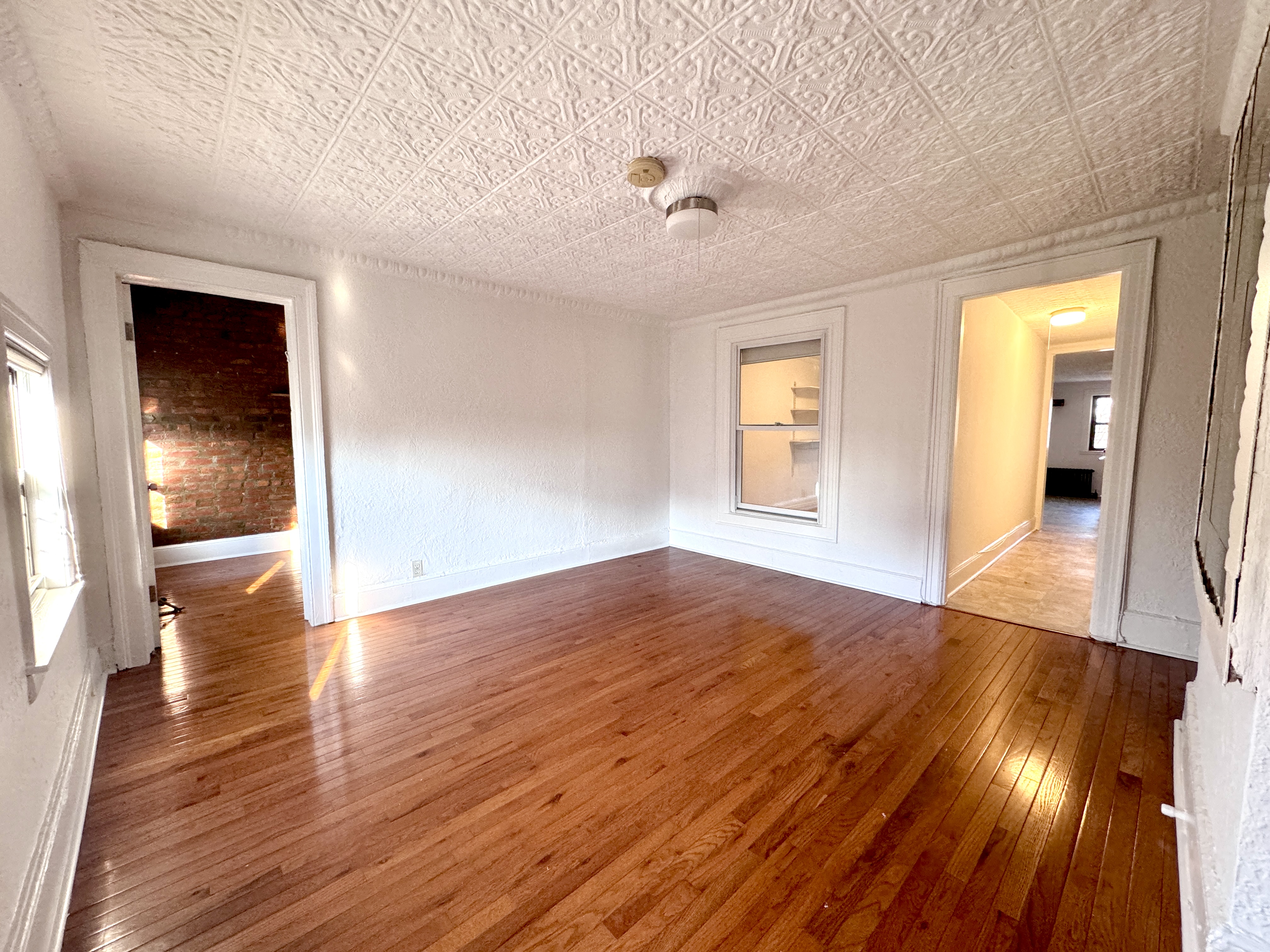 195 Court Street, Unit 4 Brooklyn, NY 11201 - Photo 2 of 11 a view of empty room with wooden floor and fan