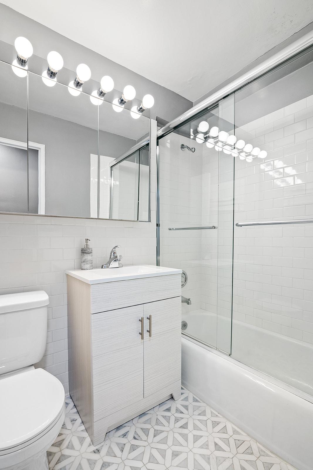 7 East 14th Street, Unit 429 Manhattan, NY 10003 - Photo 5 of 6 a bathroom with a sink toilet and shower