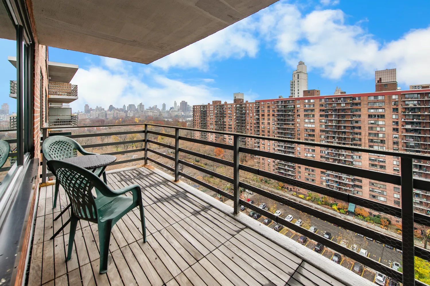 a view of a balcony with wooden benches