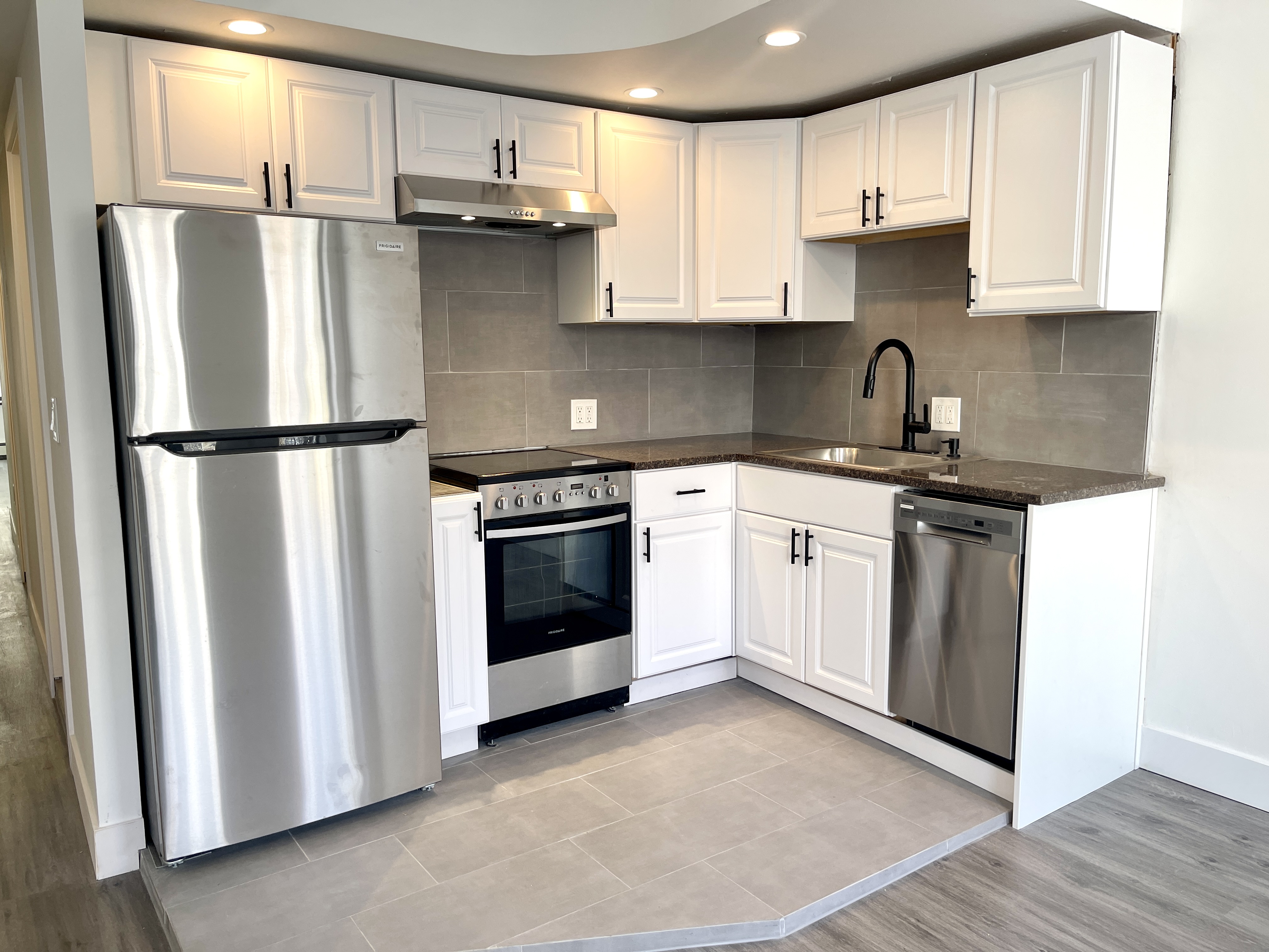 1999 3rd Avenue, Unit 1 Manhattan, NY 10029 - Photo 2 of 23 a kitchen with stainless steel appliances a refrigerator sink and cabinets
