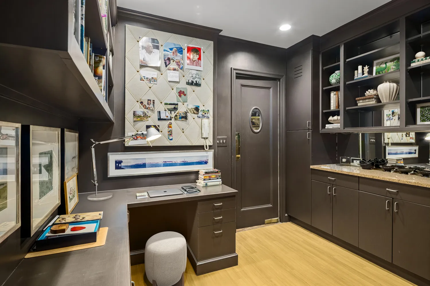 a room with stainless steel appliances kitchen island granite countertop a refrigerator and a sink