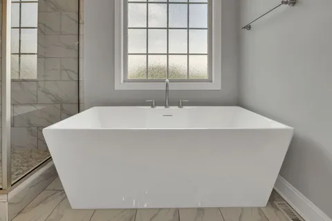 a white bath tub sitting in a bathroom