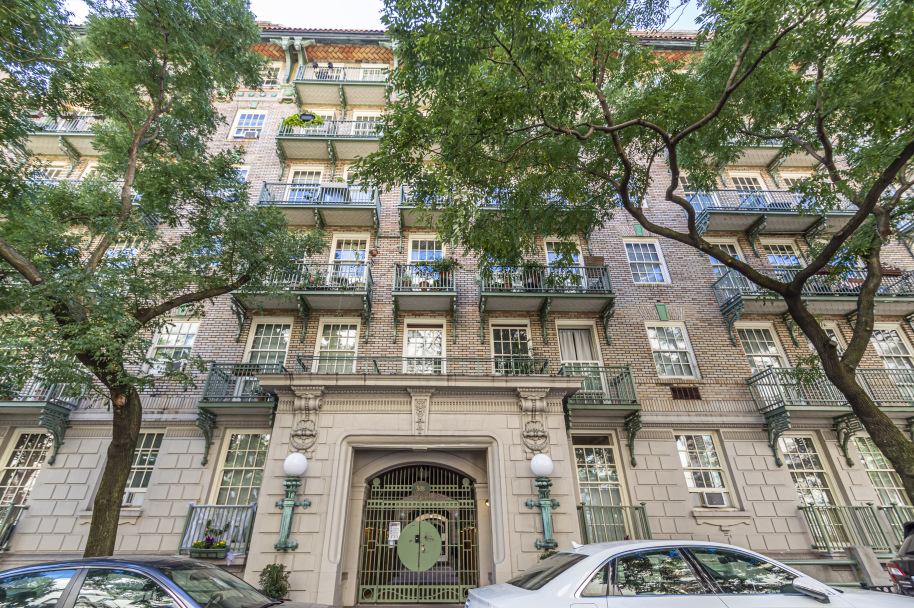 509 East 77th Street, Unit 6G Manhattan, NY 10075 - Photo 9 of 10 a front view of a building with large trees