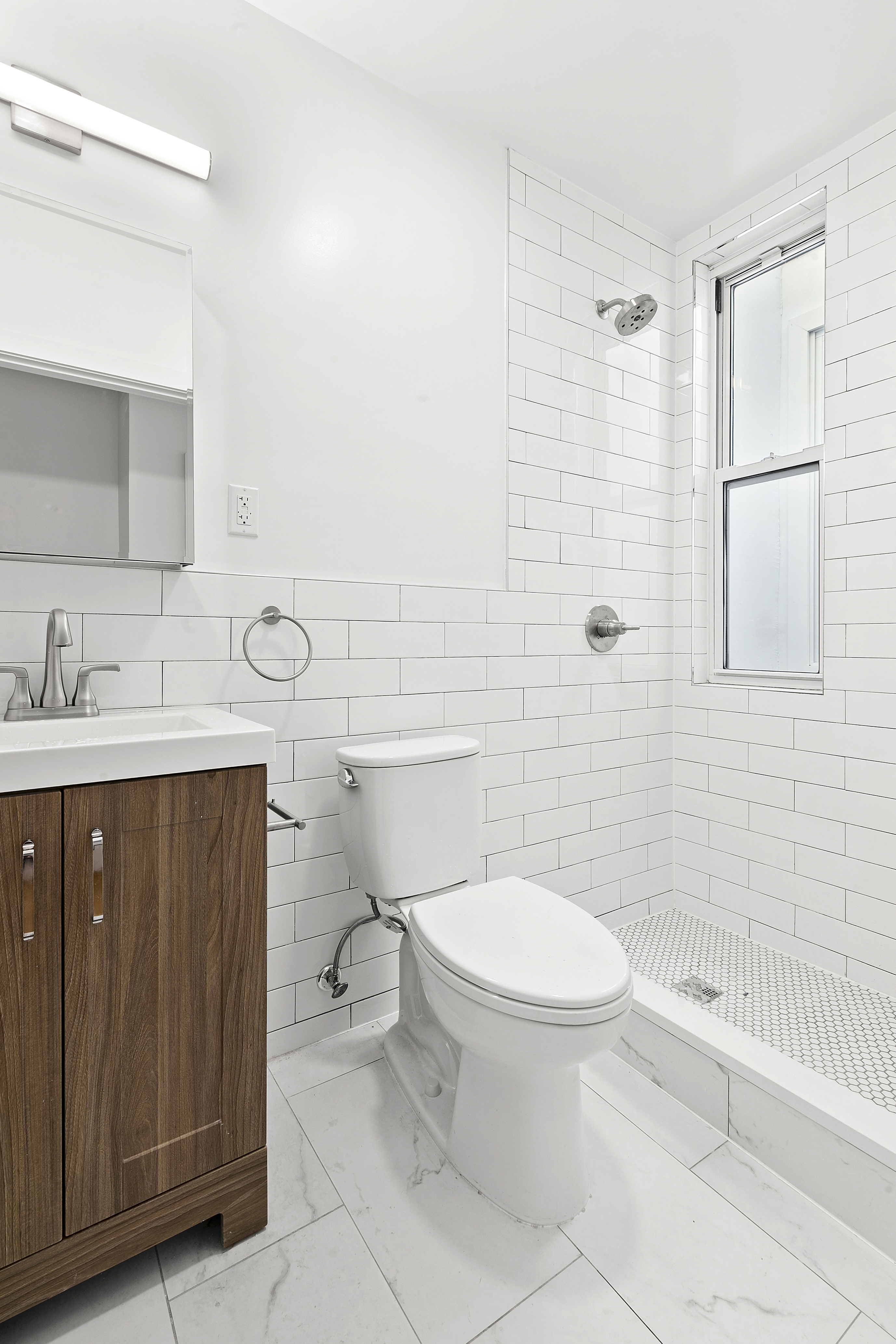 82 Clinton Avenue, Unit 1 Brooklyn, NY 11205 - Photo 5 of 11 a bathroom with a sink a toilet and shower
