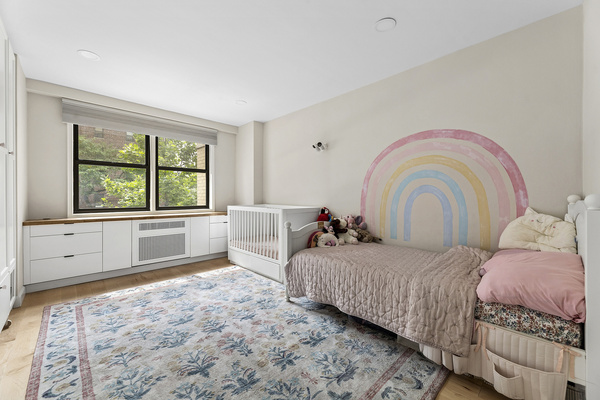 145 East 15th Street, Unit 2T Manhattan, NY 10003 - Photo 4 of 10 a bedroom with a bed and a large window