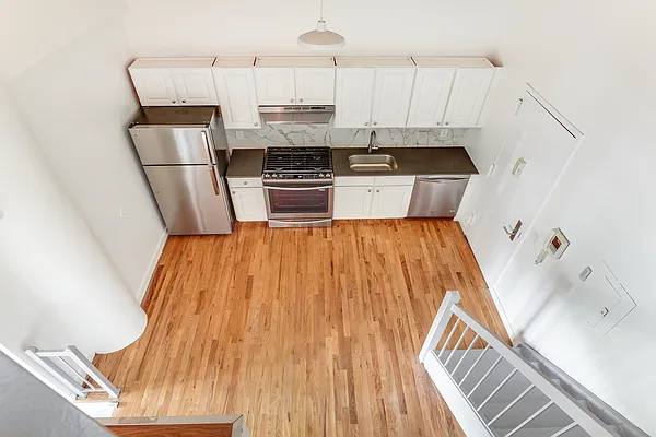 204 Huntington Street, Unit 1D Brooklyn, NY 11231 - Photo 3 of 12 a kitchen with stainless steel appliances wooden cabinets and a refrigerator