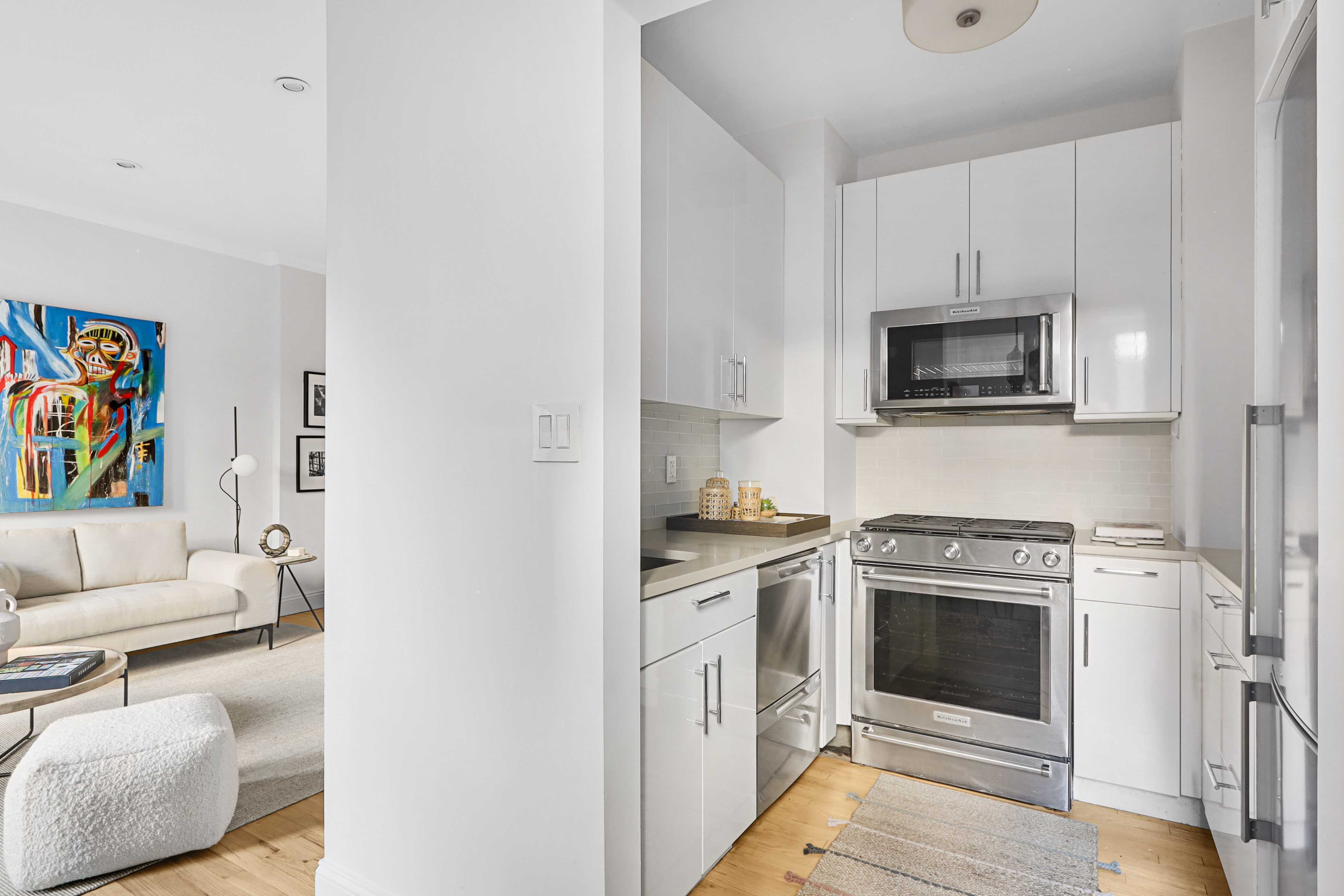 250 West 103rd Street, Unit 4A Manhattan, NY 10025 - Photo 3 of 14 a kitchen with stainless steel appliances a stove a microwave sink and cabinets